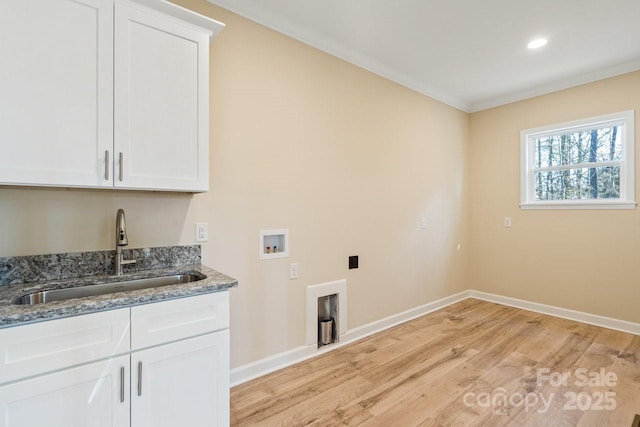 laundry area featuring cabinets, crown molding, sink, light hardwood / wood-style flooring, and washer hookup