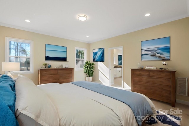 carpeted bedroom featuring ensuite bathroom and crown molding