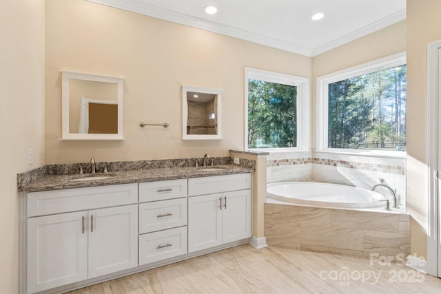 bathroom featuring vanity, a relaxing tiled tub, and ornamental molding