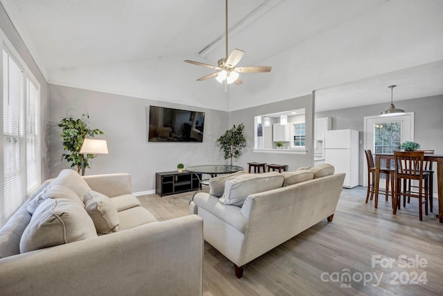 living room featuring ceiling fan, vaulted ceiling, and light hardwood / wood-style floors