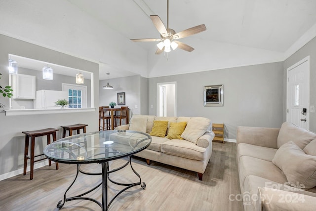 living room featuring high vaulted ceiling, light wood-type flooring, and ceiling fan