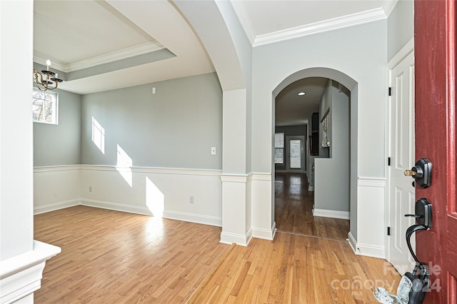 foyer entrance featuring light wood-type flooring and ornamental molding