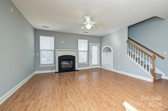 unfurnished living room featuring ceiling fan and light hardwood / wood-style flooring