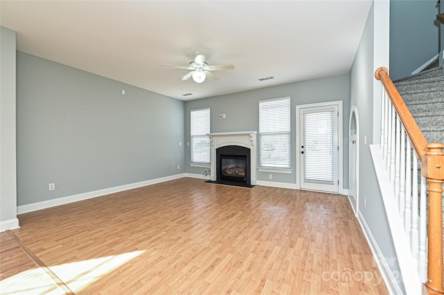 unfurnished living room featuring light wood-type flooring and ceiling fan