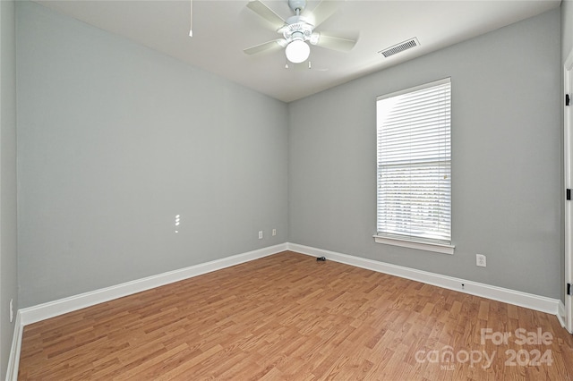 empty room featuring ceiling fan and light wood-type flooring