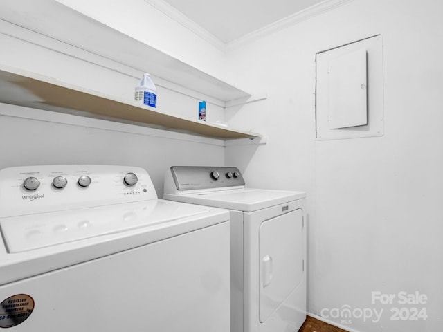 laundry area featuring washer and clothes dryer, electric panel, and ornamental molding