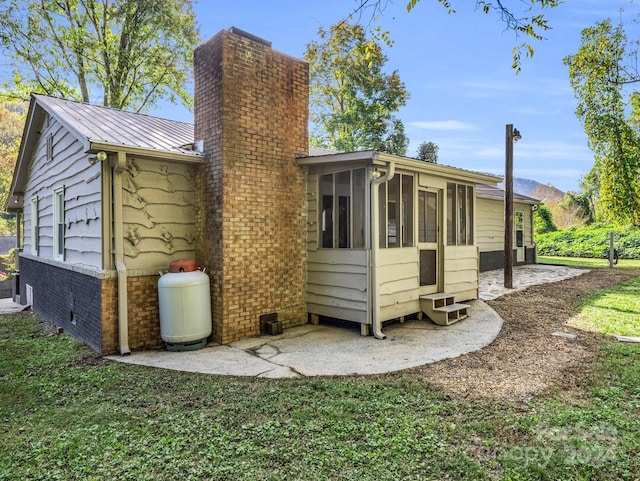 rear view of property with a sunroom