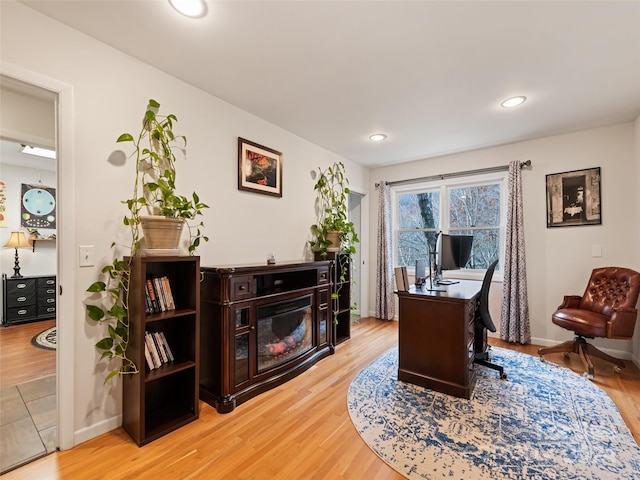 home office with hardwood / wood-style floors