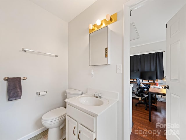 bathroom with hardwood / wood-style floors, vanity, and toilet