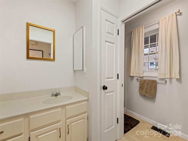 bathroom featuring tile patterned flooring and vanity