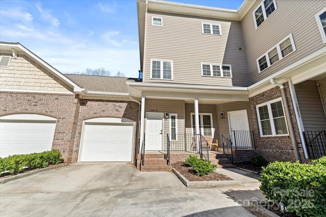 view of front of home with a porch and a garage