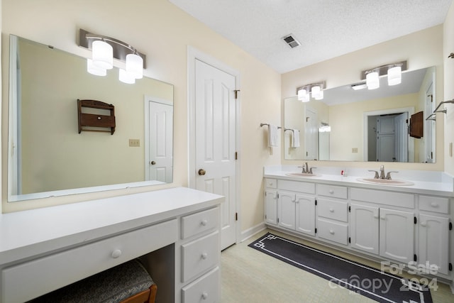 bathroom featuring vanity and a textured ceiling