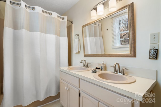 bathroom featuring vanity and a textured ceiling