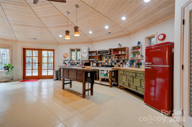 interior space with french doors, wood ceiling, refrigerator, hanging light fixtures, and sink