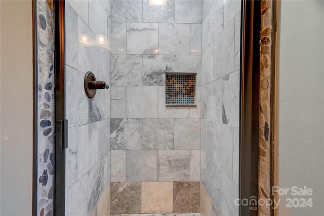 bathroom with a tile shower