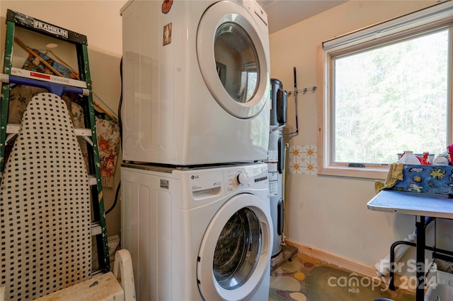 clothes washing area with stacked washer and dryer