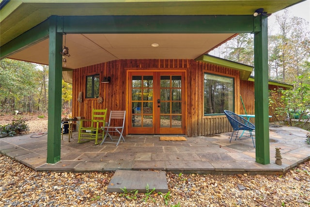 view of exterior entry with a patio area and french doors