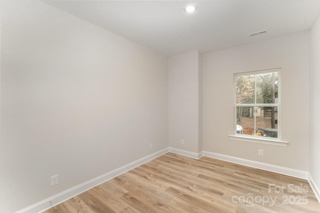 unfurnished room featuring visible vents, recessed lighting, light wood-type flooring, and baseboards