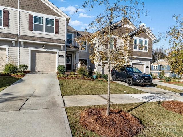 view of front of property featuring a garage and a front yard