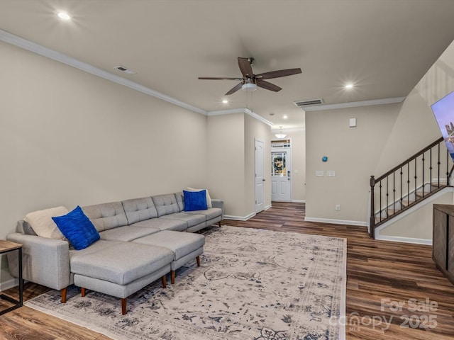 living room with ceiling fan, dark wood-type flooring, and ornamental molding