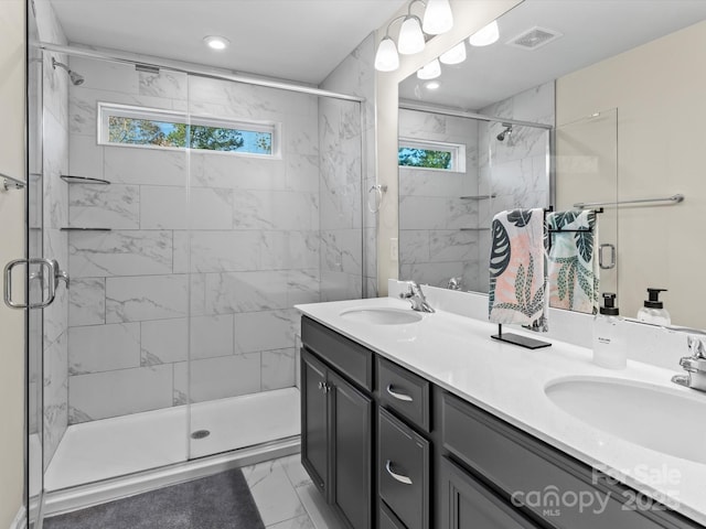 bathroom with a shower with shower door and vanity