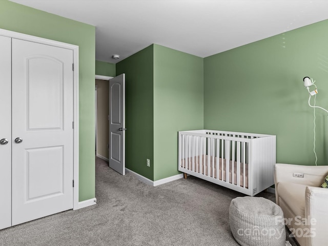 bedroom featuring a closet, a nursery area, and light carpet