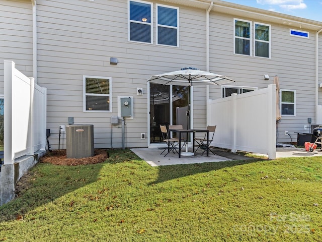 back of house with a patio area, central AC unit, and a lawn