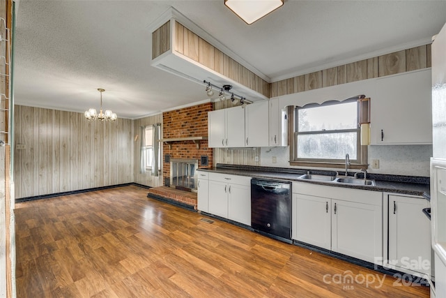 kitchen with white cabinetry, dishwasher, sink, a chandelier, and light hardwood / wood-style floors