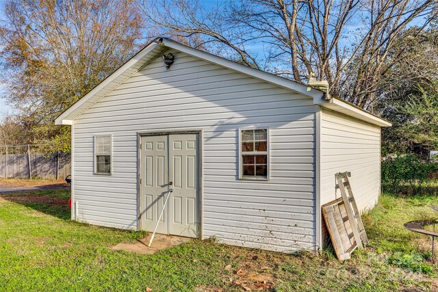 view of outbuilding featuring a lawn