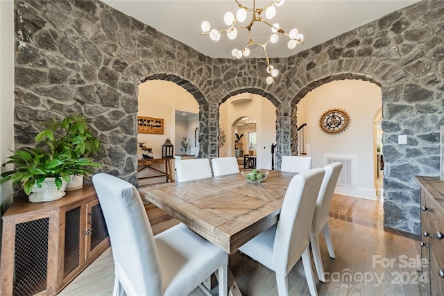 dining room with a chandelier and light hardwood / wood-style flooring