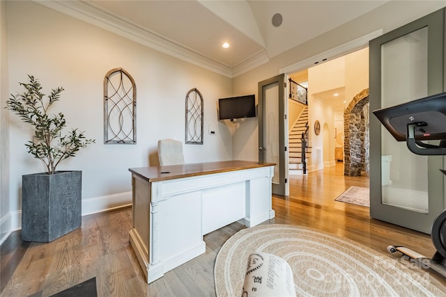 office area with wood-type flooring, crown molding, and vaulted ceiling