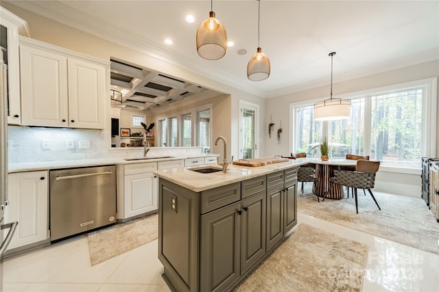 kitchen with stainless steel dishwasher, hanging light fixtures, a kitchen island with sink, and tasteful backsplash