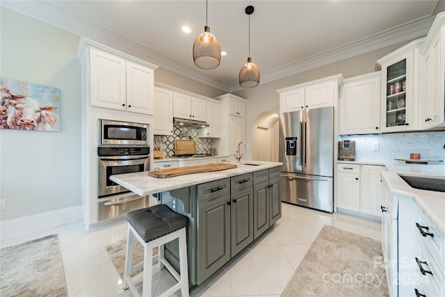 kitchen featuring gray cabinetry, white cabinetry, appliances with stainless steel finishes, backsplash, and pendant lighting