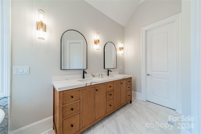 bathroom featuring lofted ceiling and vanity