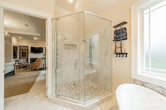 bathroom featuring crown molding and separate shower and tub