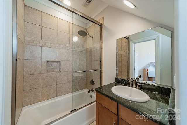 bathroom with enclosed tub / shower combo and vanity