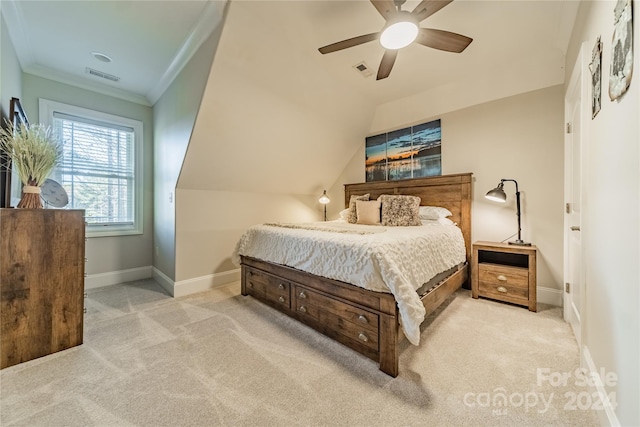 bedroom with crown molding, light carpet, ceiling fan, and lofted ceiling