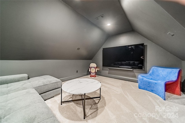 carpeted cinema room with lofted ceiling