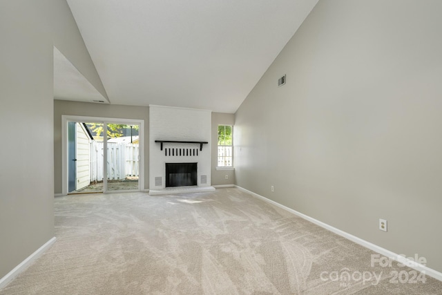 unfurnished living room with a fireplace, plenty of natural light, and light carpet