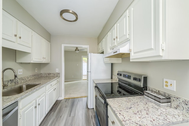 kitchen featuring light stone counters, appliances with stainless steel finishes, sink, light hardwood / wood-style floors, and white cabinets