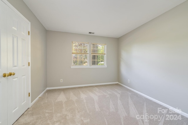 spare room with light colored carpet