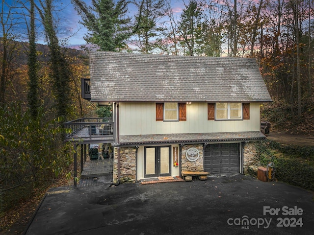 view of front of property with a garage and a balcony