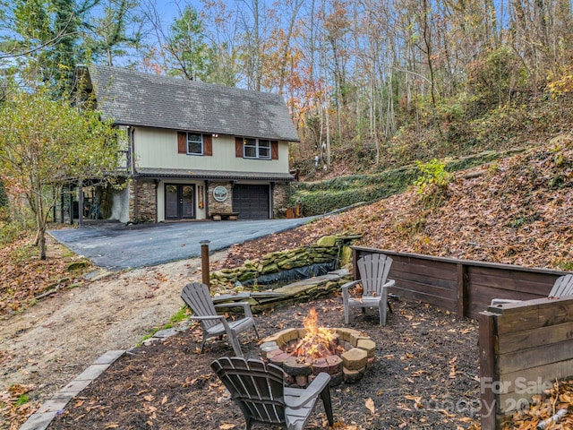 view of yard with a garage and a fire pit