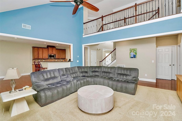 16404 Grassy Creek Dr, Huntersville, NC 28078 - living room with ceiling fan, a high ceiling, baseboards, and stairs