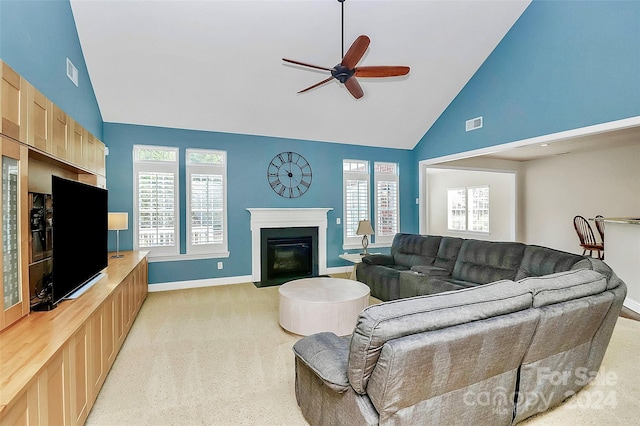 16404 Grassy Creek Dr, Huntersville, NC 28078 - living area with high vaulted ceiling, light carpet, ceiling fan, a fireplace with flush hearth, and baseboards