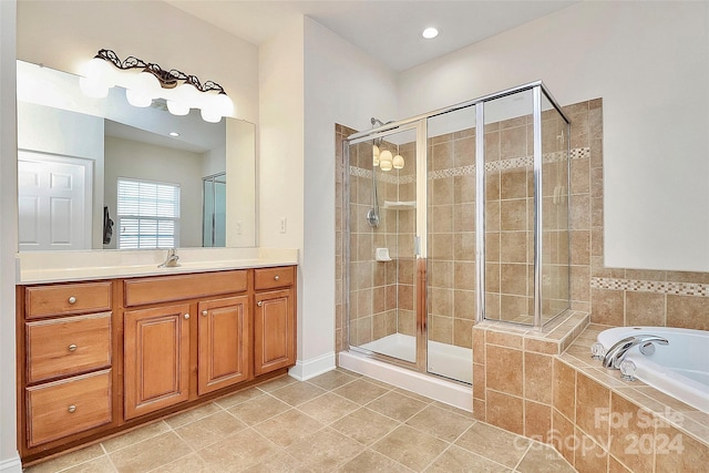 bathroom with vanity, plus walk in shower, and tile patterned flooring