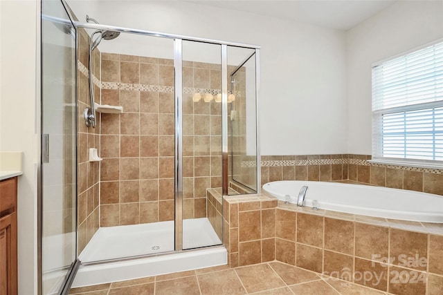 bathroom with vanity, tile patterned floors, and plus walk in shower