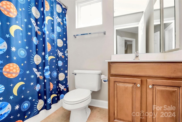 bathroom with toilet, vanity, tile patterned floors, and walk in shower