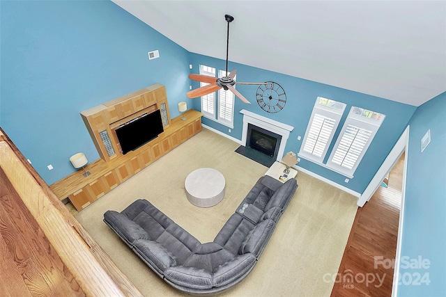 16404 Grassy Creek Dr, Huntersville, NC 28078 - living area featuring a tile fireplace, ceiling fan, baseboards, wood finished floors, and high vaulted ceiling