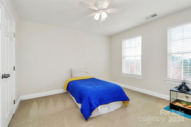 carpeted bedroom featuring ceiling fan